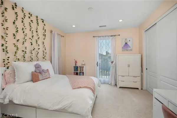 a bedroom with a bed and a painting on the wall