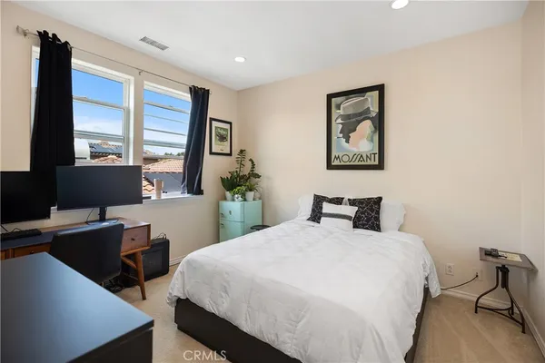 a bedroom with a bed and a desk