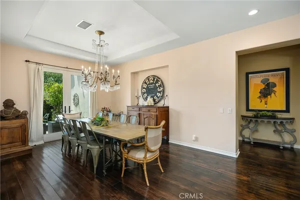 a view of a dining room with furniture wooden floor and chandelier