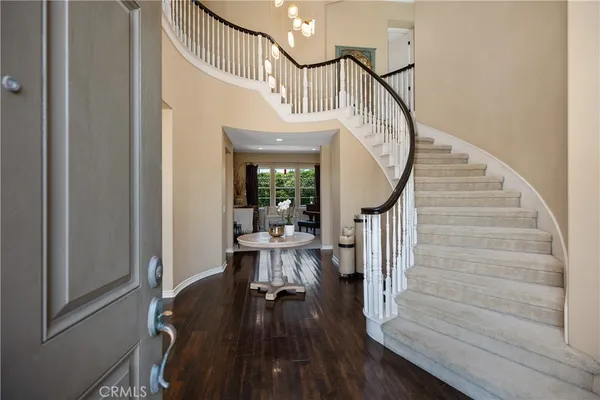 a view of entryway and hall with wooden floor