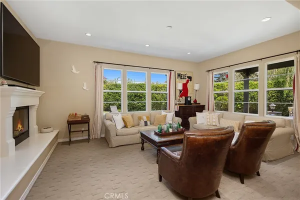 a living room with fireplace furniture and a flat screen tv