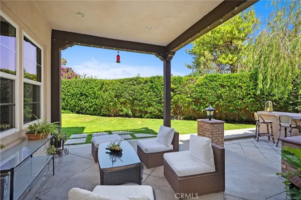 a view of an outdoor dining space with furniture and garden