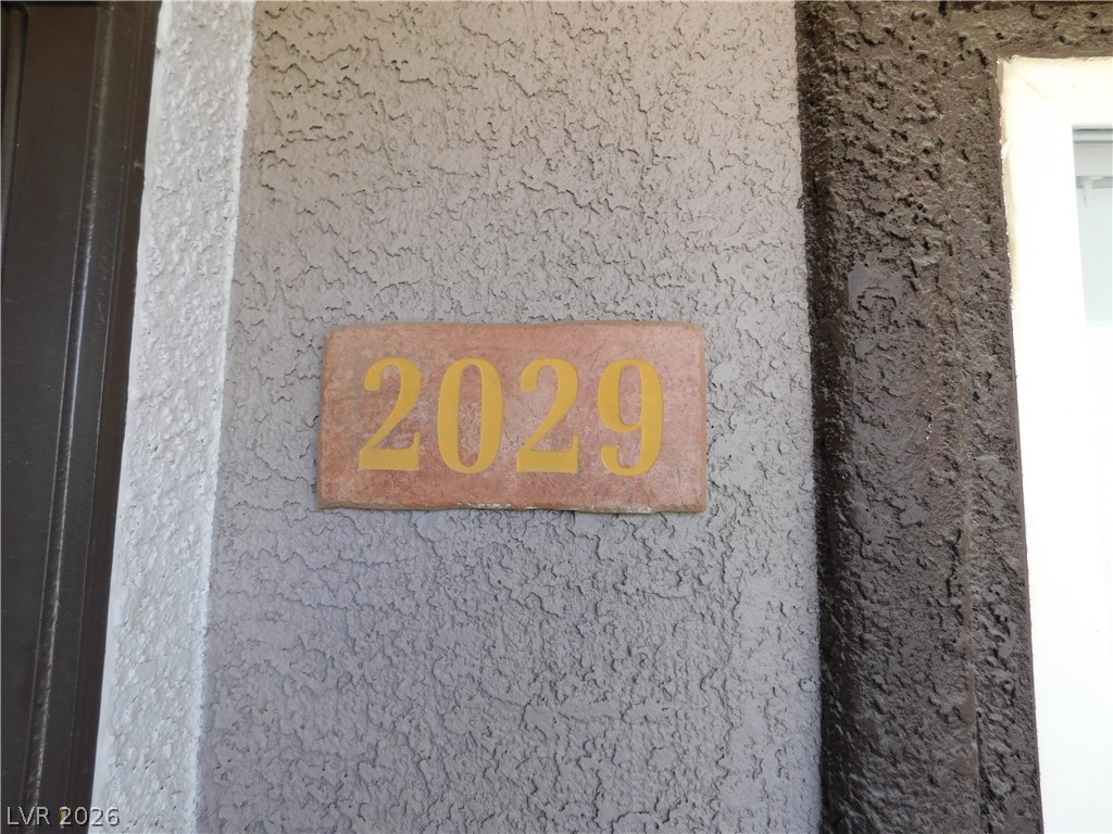 Clearly visible address numbers are mounted on textured exterior siding.