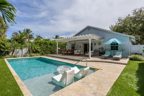 a view of a house with swimming pool and sitting area