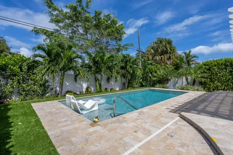 a view of a backyard with a tree