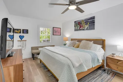 a bedroom with a bed and a chandelier