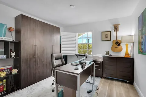 a view of a workspace with furniture and a dresser