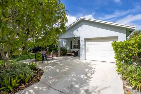 a view of a house with a yard and sitting area