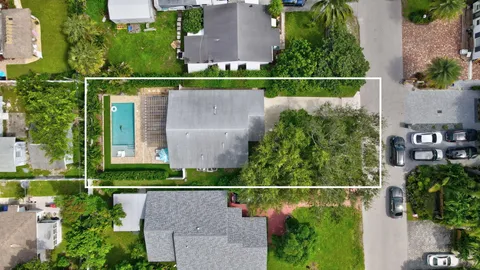 an aerial view of a house with a garden and a yard