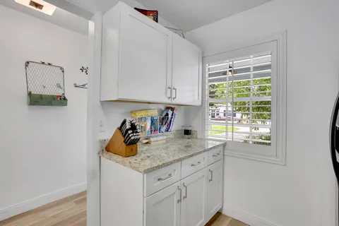 a kitchen with stainless steel appliances granite countertop a sink and a window