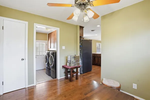 a view of a hallway with furniture and wooden floor