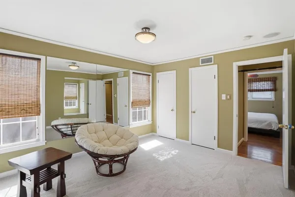 a view of a livingroom with furniture and a window