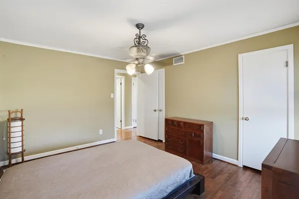 a bedroom with a bed and a dresser