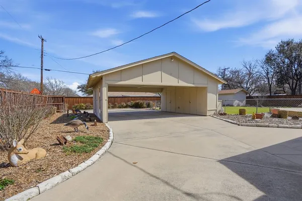 a view of a livingroom with wooden floor and a table chair