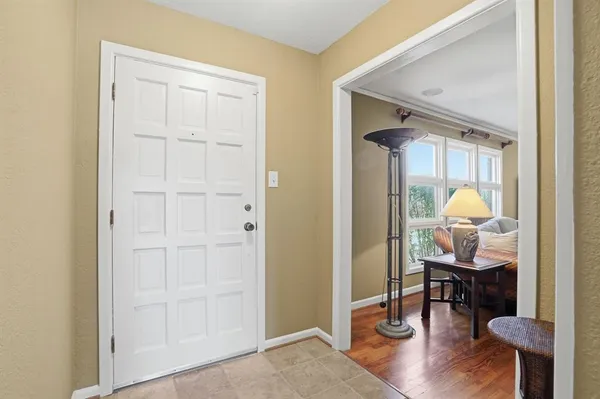 a living room with furniture a table and a large window