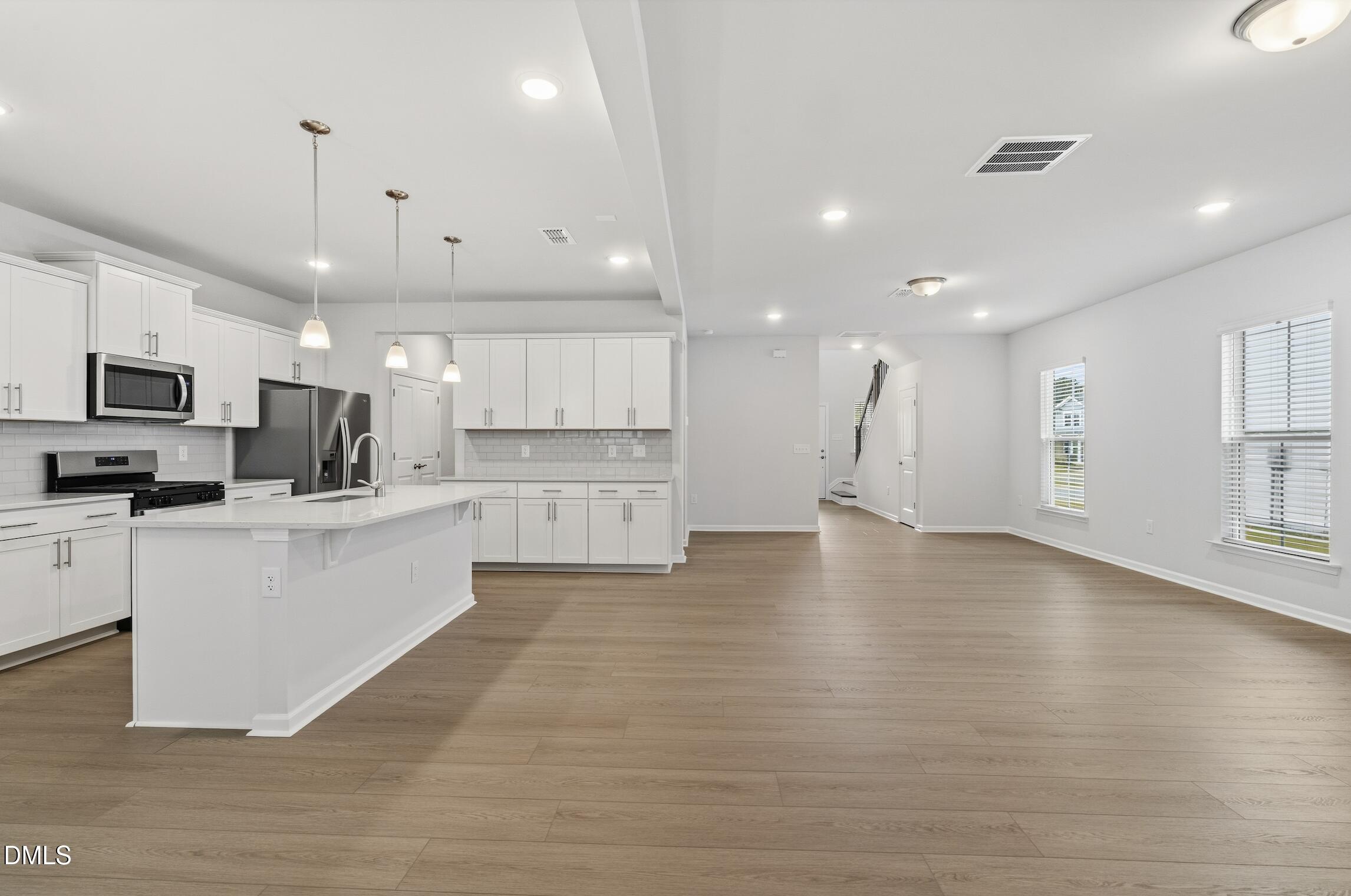 505 Providence Springs Lane Fuquay-Varina, NC 27526 - Photo 11 of 40 a view of kitchen with cabinets microwave and stove