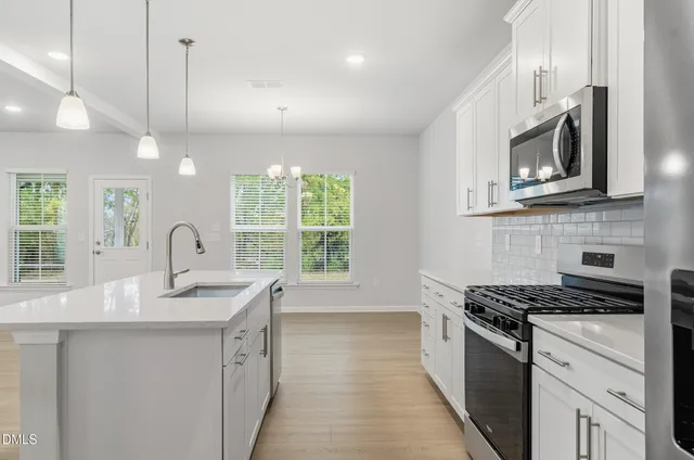 a kitchen with sink a microwave and stove
