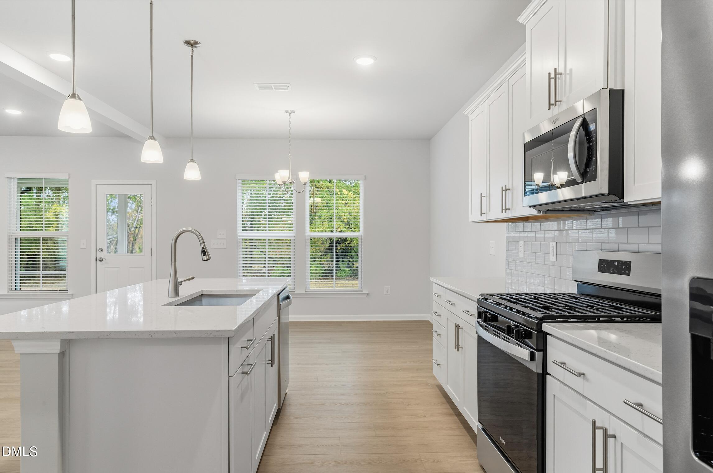 505 Providence Springs Lane Fuquay-Varina, NC 27526 - Photo 16 of 40 a kitchen with sink a microwave and stove