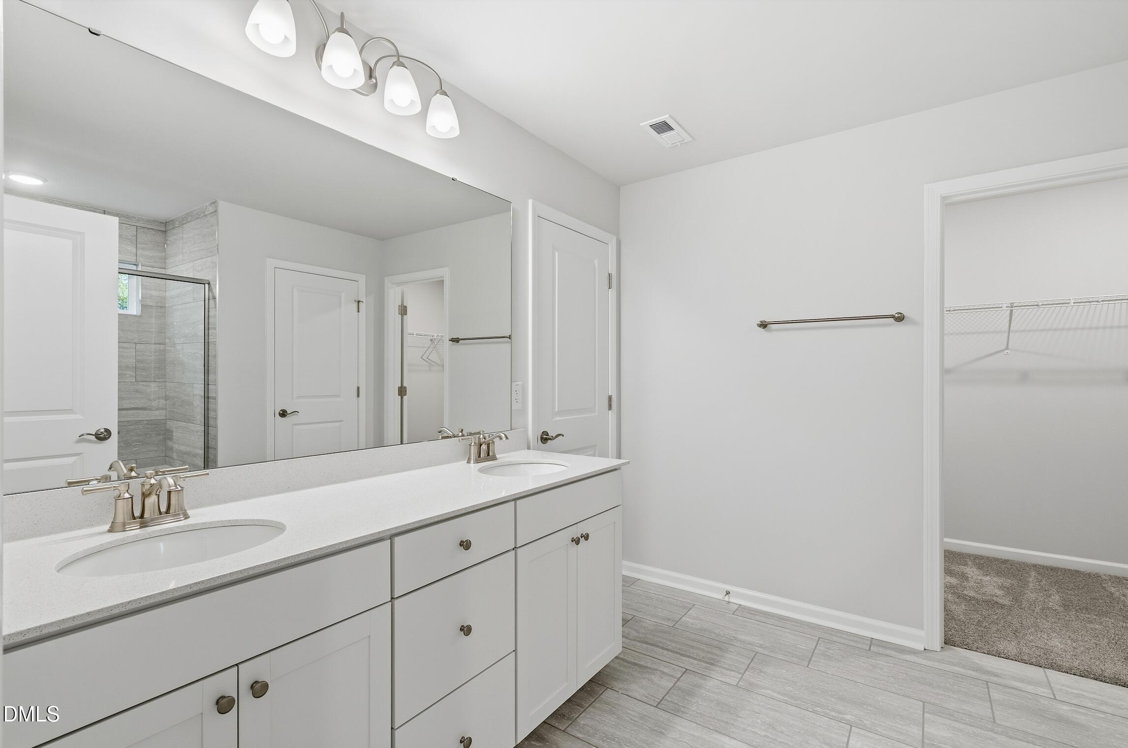 505 Providence Springs Lane Fuquay-Varina, NC 27526 - Photo 30 of 40 a spacious bathroom with a double vanity sink and a mirror