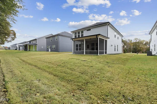 a view of a house with yard and sitting area