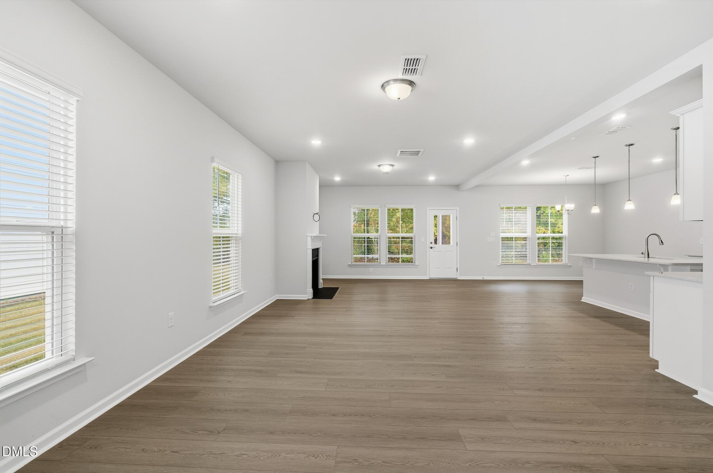 505 Providence Springs Lane Fuquay-Varina, NC 27526 - Photo 6 of 40 an empty room with wooden floor and windows
