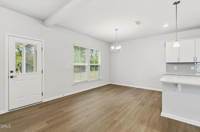 a view of a kitchen with wooden floor and a sink