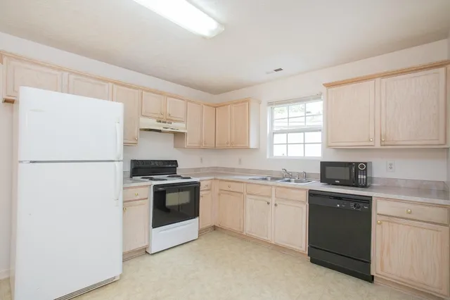 a kitchen with a white cabinets and white appliances