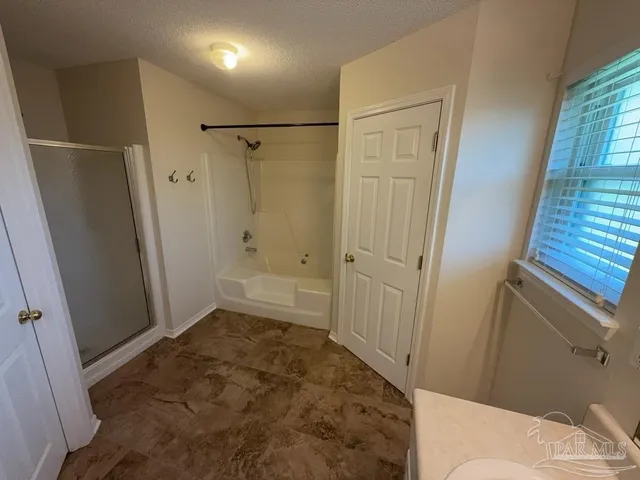 a bathroom with a sink and shower
