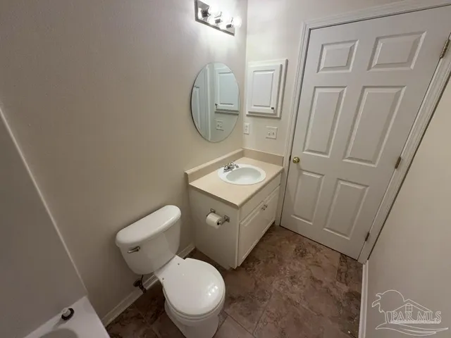 a white toilet sitting next to a bathroom sink