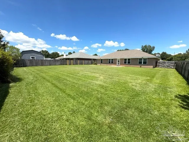 a view of an house with a big yard