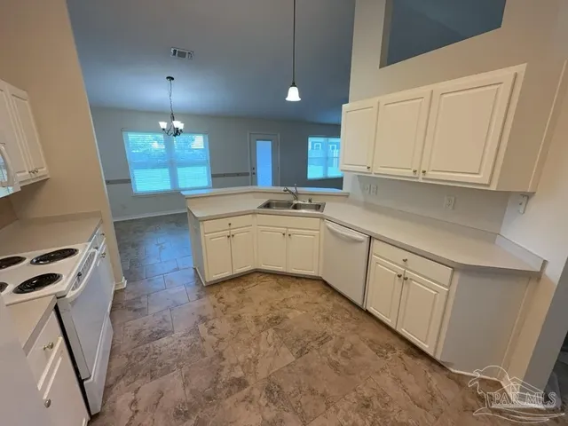 a kitchen with a sink cabinets and window