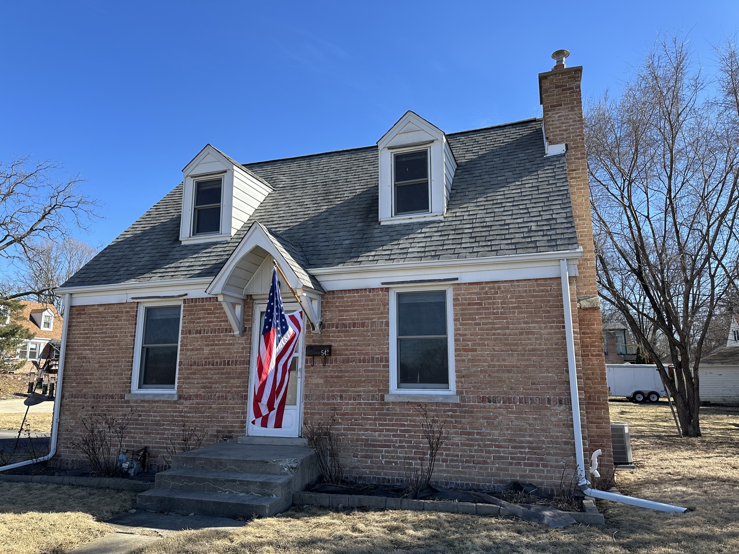 542 Sycamore Road DeKalb, IL 60115 - Photo 1 of 17 a front view of a house with large trees