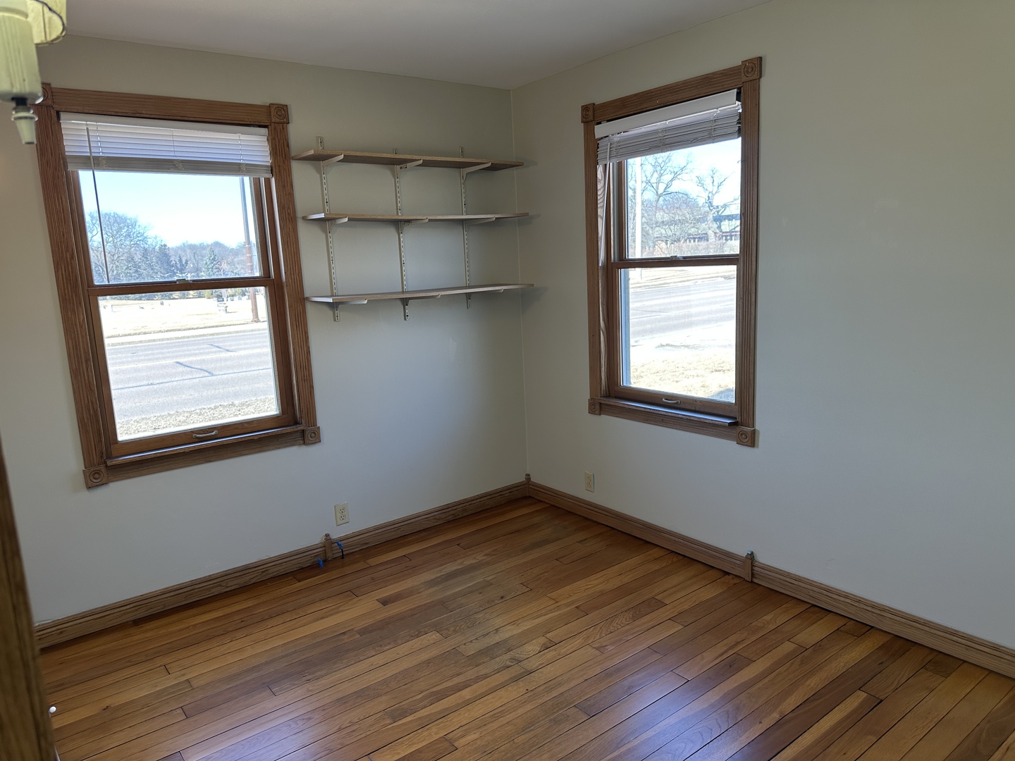 542 Sycamore Road DeKalb, IL 60115 - Photo 11 of 17 an empty room with wooden floor and windows