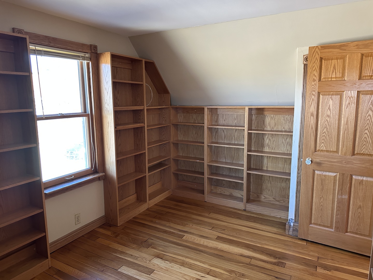 542 Sycamore Road DeKalb, IL 60115 - Photo 12 of 17 an empty room with wooden floor and windows