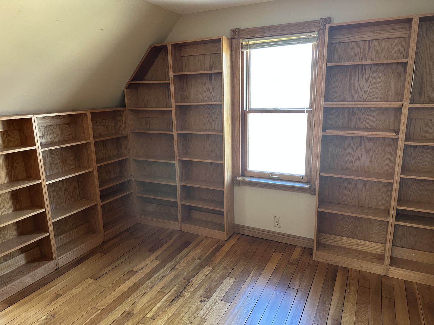 542 Sycamore Road DeKalb, IL 60115 - Photo 13 of 17 a view of an empty room with wooden floor and a window