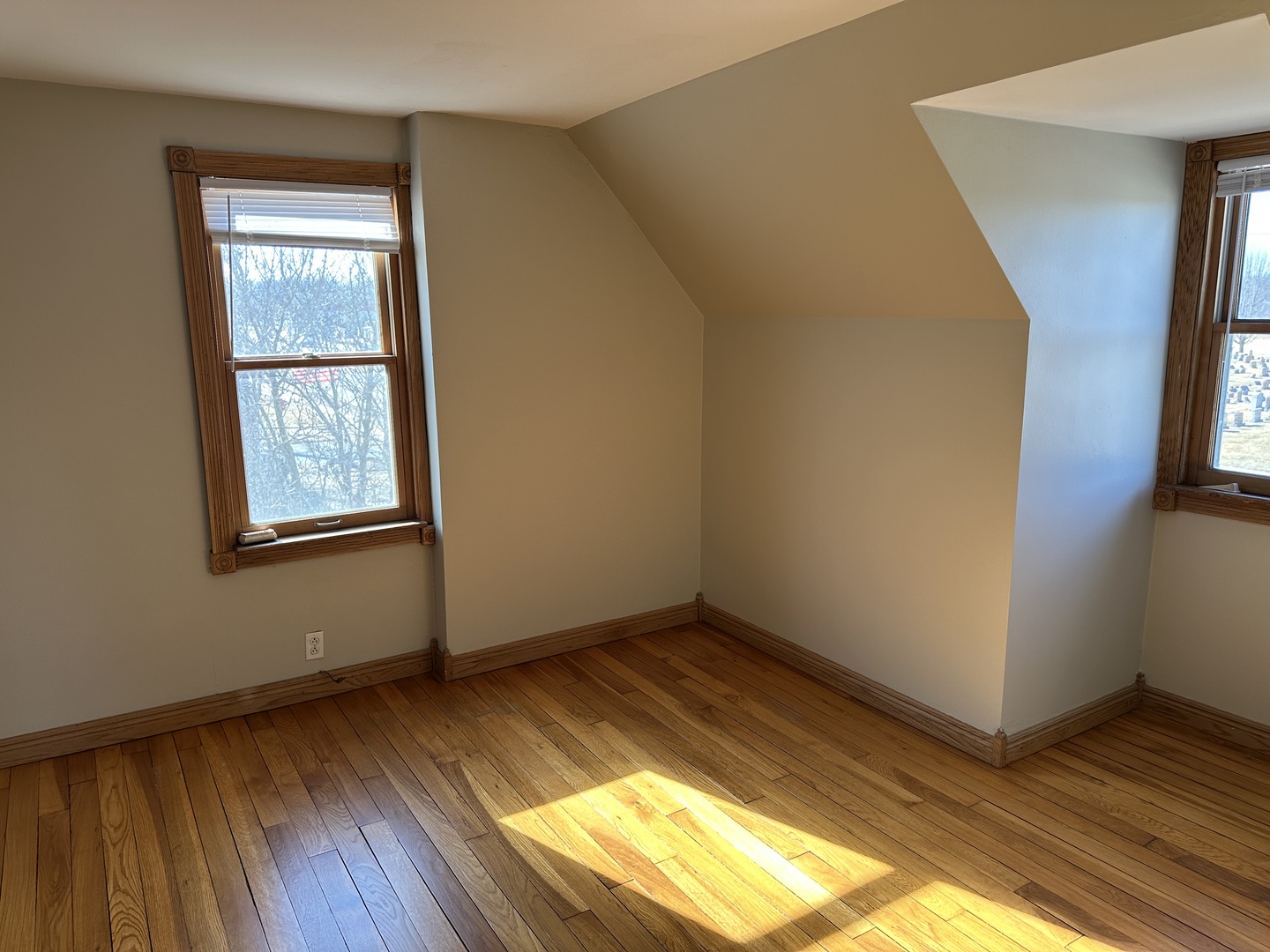 542 Sycamore Road DeKalb, IL 60115 - Photo 14 of 17 a view of an empty room with wooden floor and a window