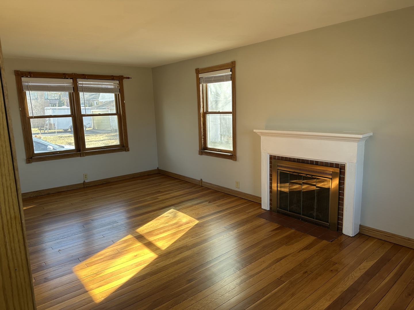 542 Sycamore Road DeKalb, IL 60115 - Photo 4 of 17 a view of empty room with wooden floor and fan