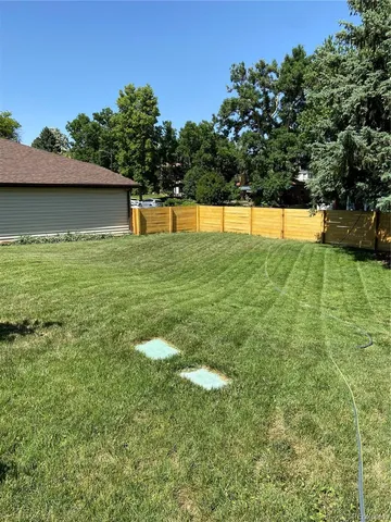 a kitchen with stainless steel appliances granite countertop a stove a sink and white cabinets
