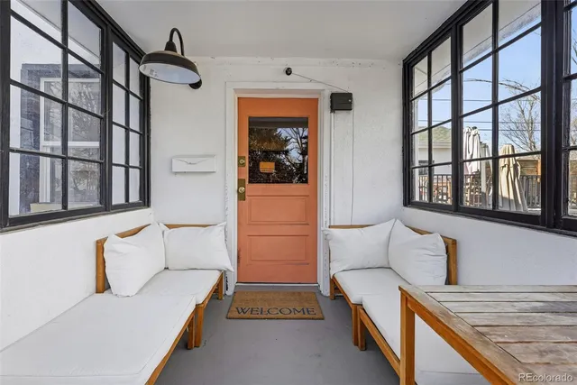 a spacious bedroom with a bed lamp and a window