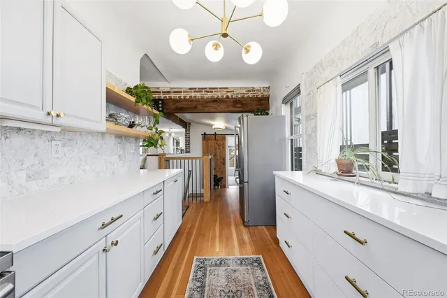 a view of a kitchen with a sink and cabinets