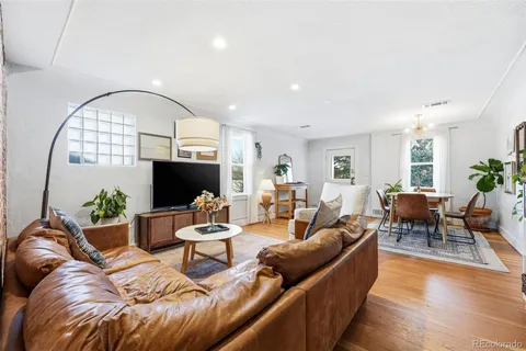 a living room with furniture kitchen view and a flat screen tv