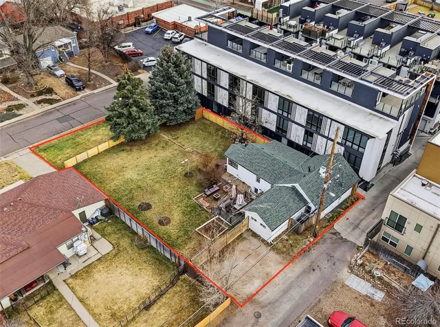 an aerial view of residential houses with outdoor space