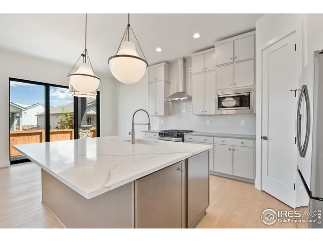 a kitchen with kitchen island a sink stainless steel appliances and cabinets