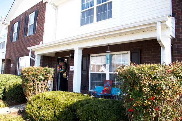 a view of a house with potted plants