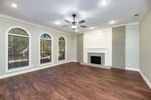 a view of a room with chandelier fan and windows