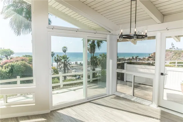a view of a room with a window and wooden floor