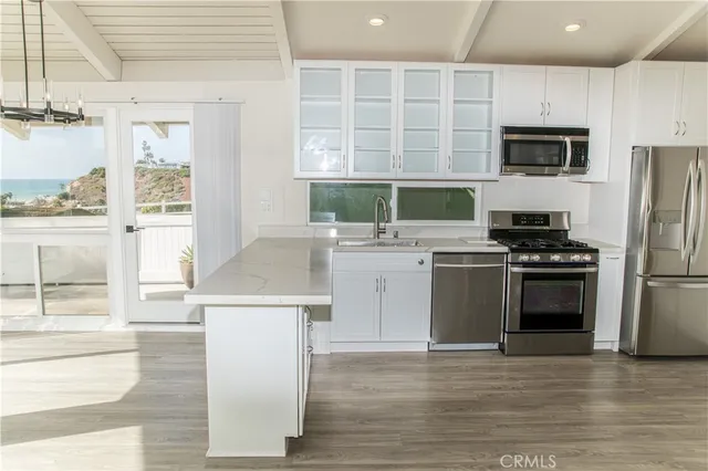 a kitchen with a sink appliances and cabinets
