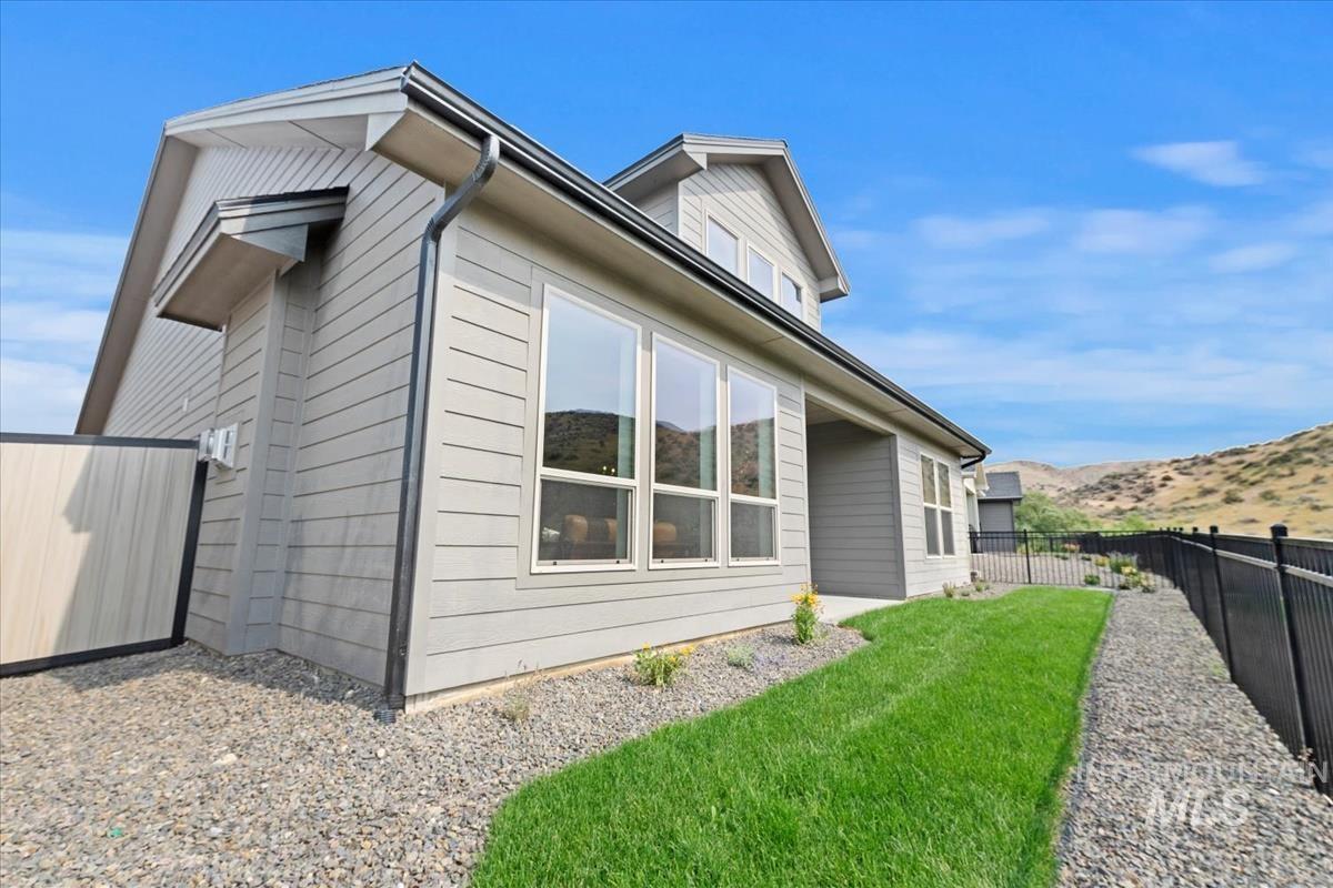 2166 East Rodeo Street Kuna, ID 83634 - Photo 40 of 43 Modern exterior with gray horizontal siding and a black metal fence