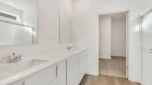 a bathroom with a double vanity sink and a mirror