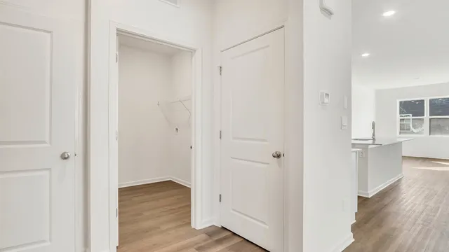 a view of a hallway with wooden floor